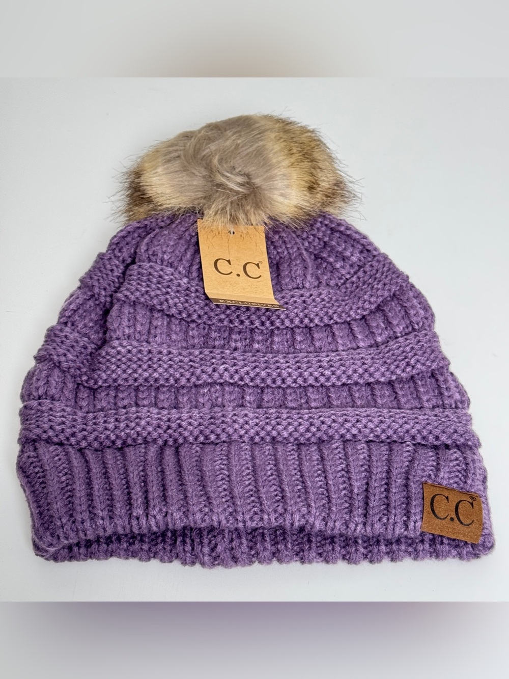 Brand new C.C. Exclusives purple cable knit beanie with a cozy brown/tan fauxfur